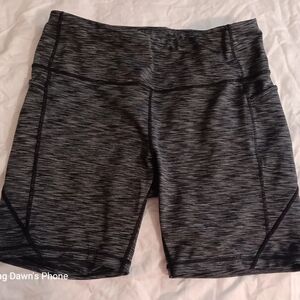 Women's athletic shorts, high waist with side pockets.